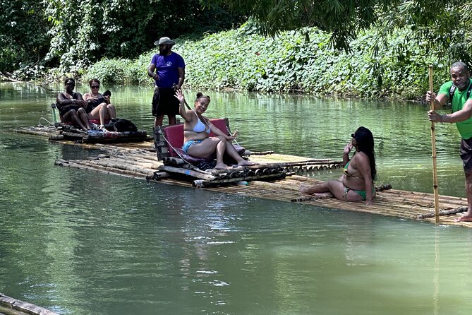 Experience Day Rafting on the Martha Brae River - Getting ready with a life vest and a cool drink